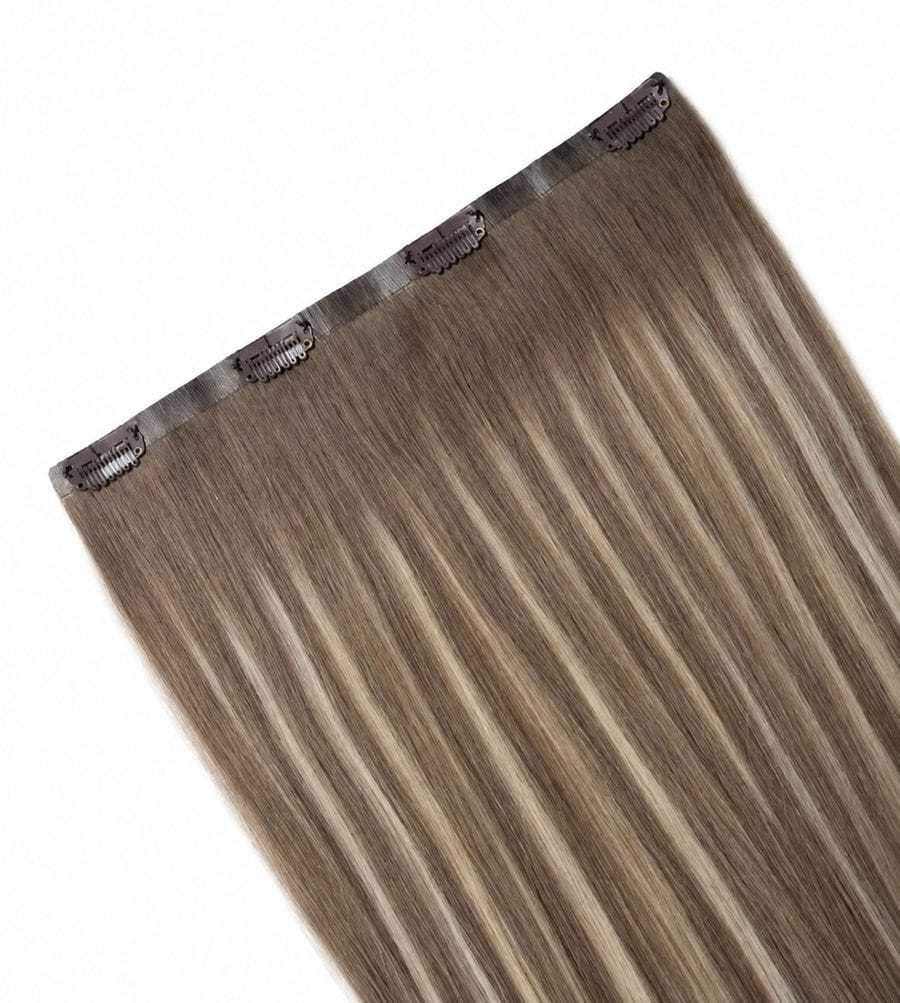 Clip-in hair extension in straight, light brown with blonde highlights on a white background.