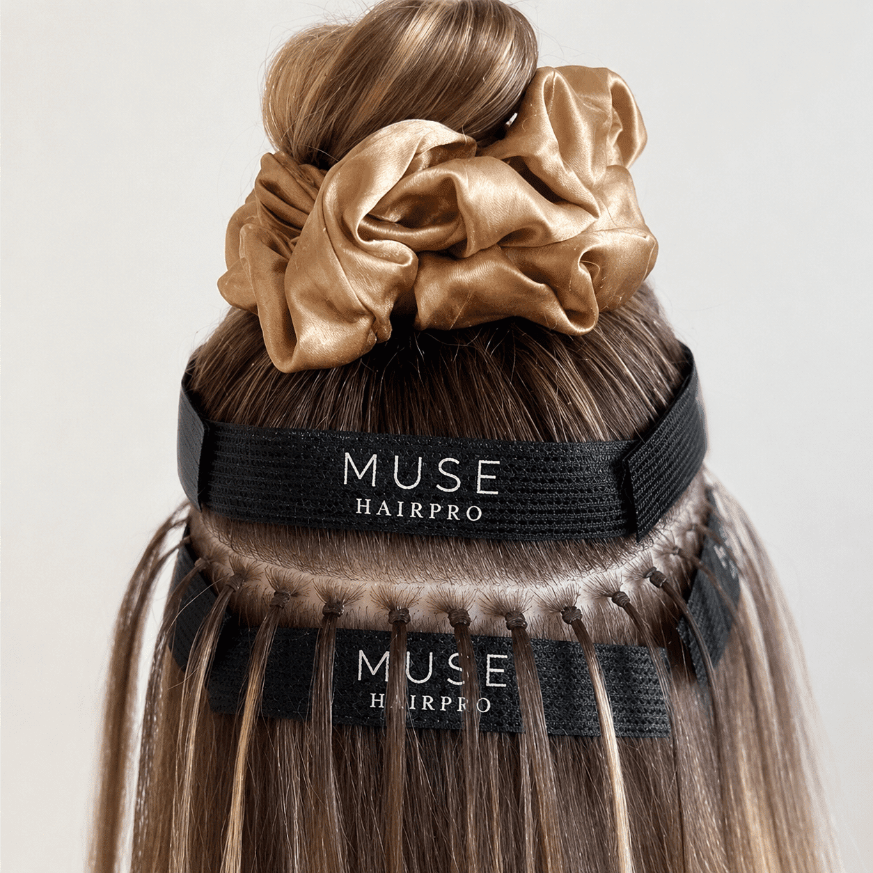 Hair extensions application with blonde hair and Muse HairPro bands.