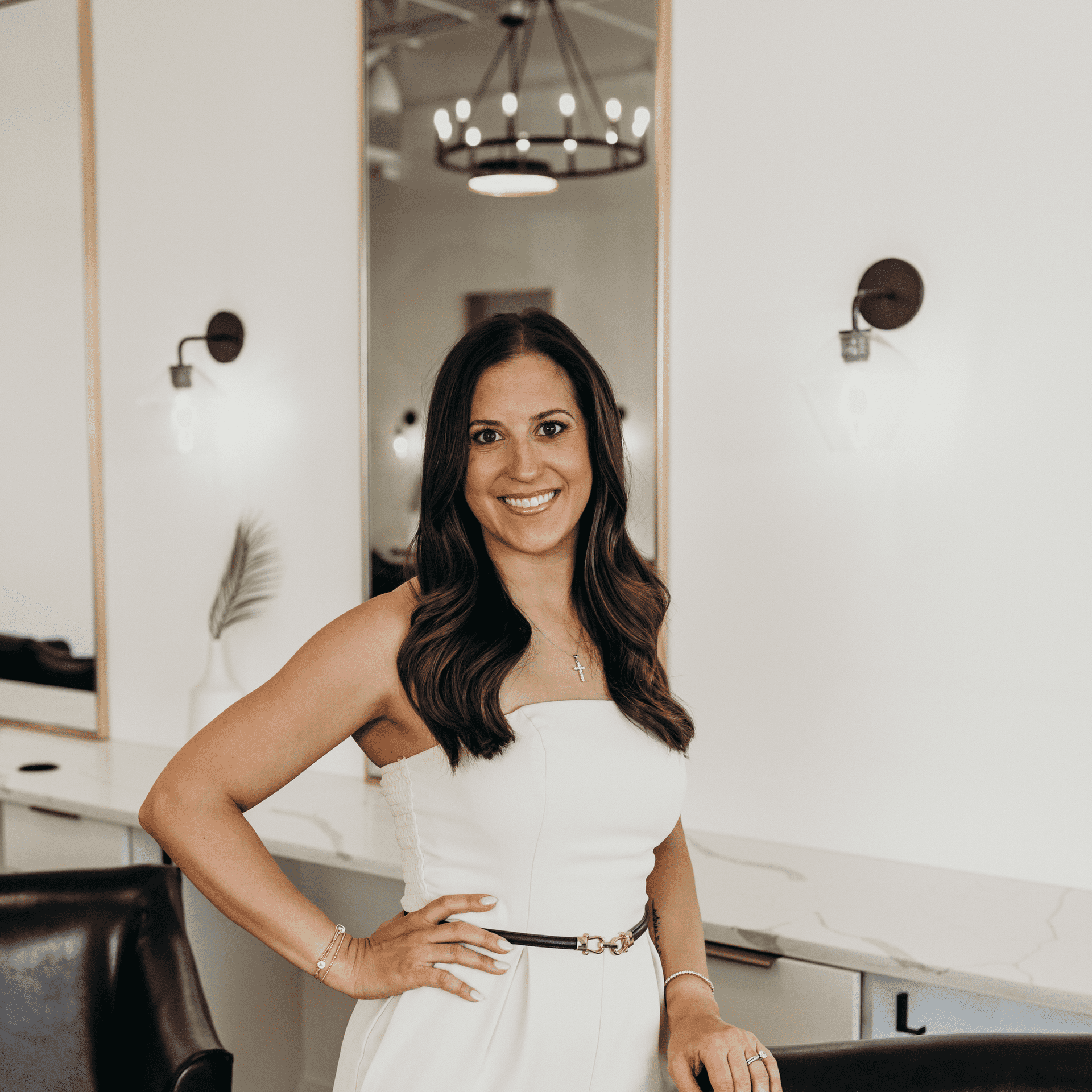 Portrait of Elisa, a professional stylist at Meraki Salon And Extensions, showcasing their expertise and style.