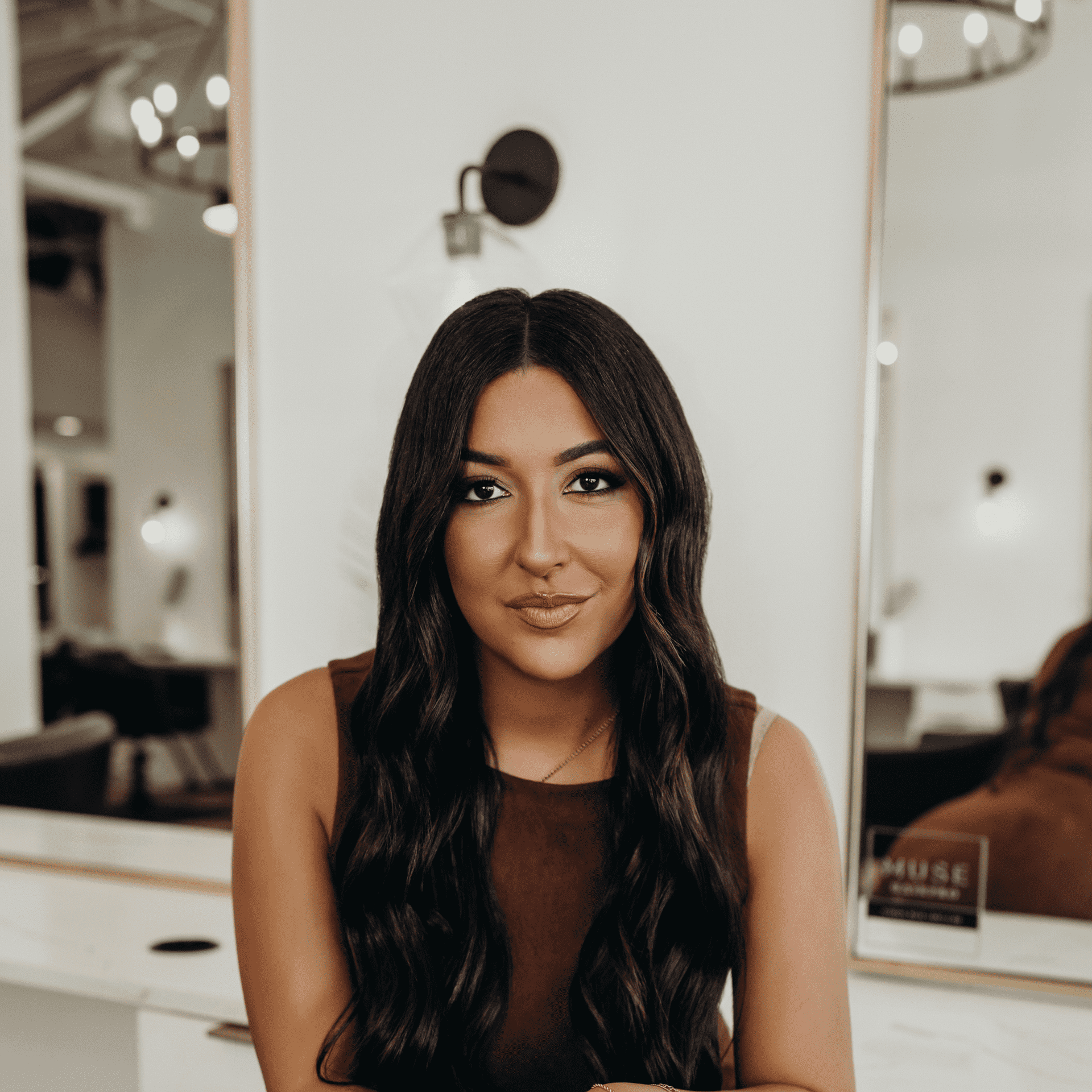 Portrait of Ari, a professional stylist at Meraki Salon And Extensions, showcasing their expertise and style.