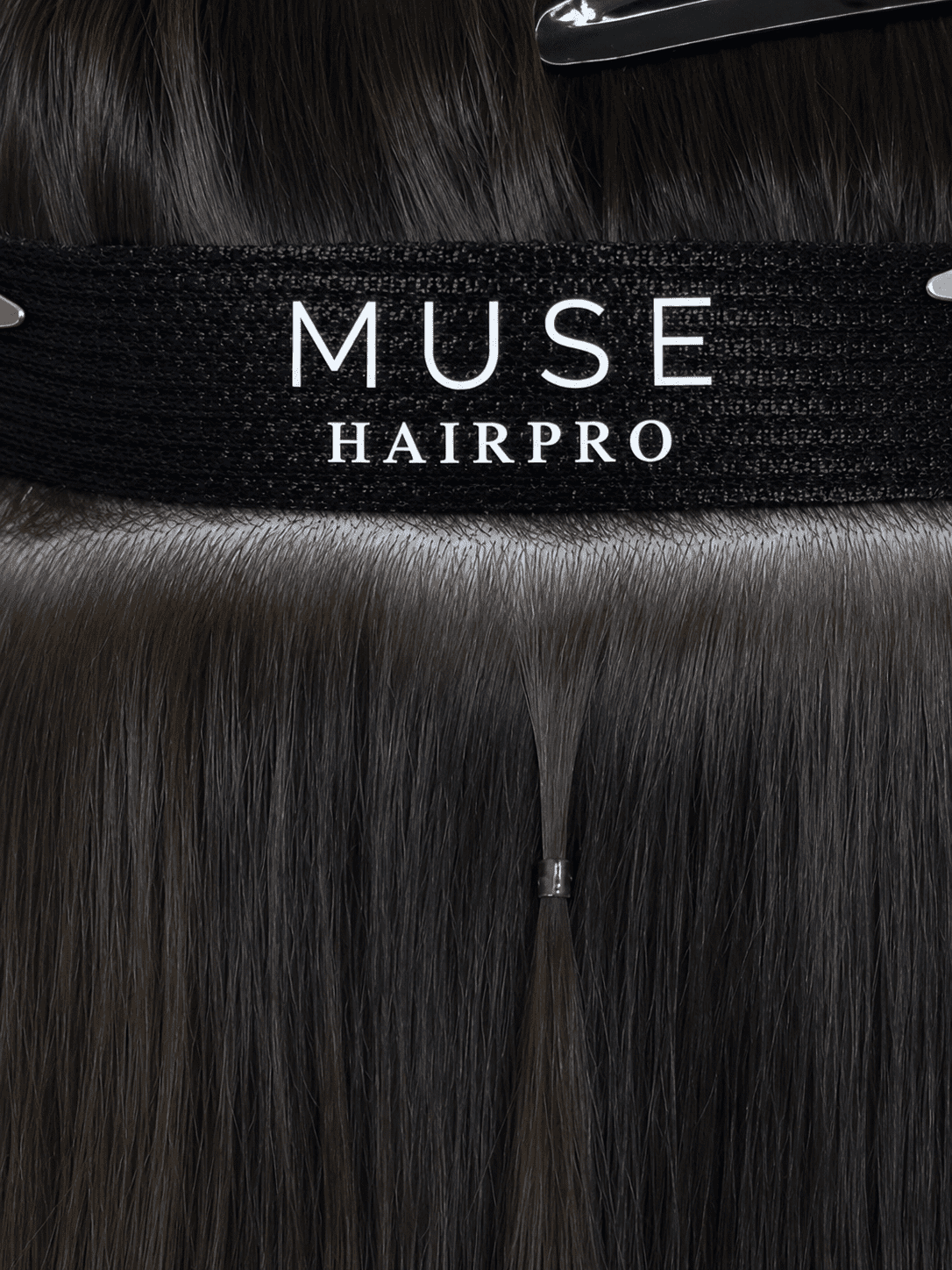 Close-up of brown hair extensions from Muse HairPro, showing attachment details.