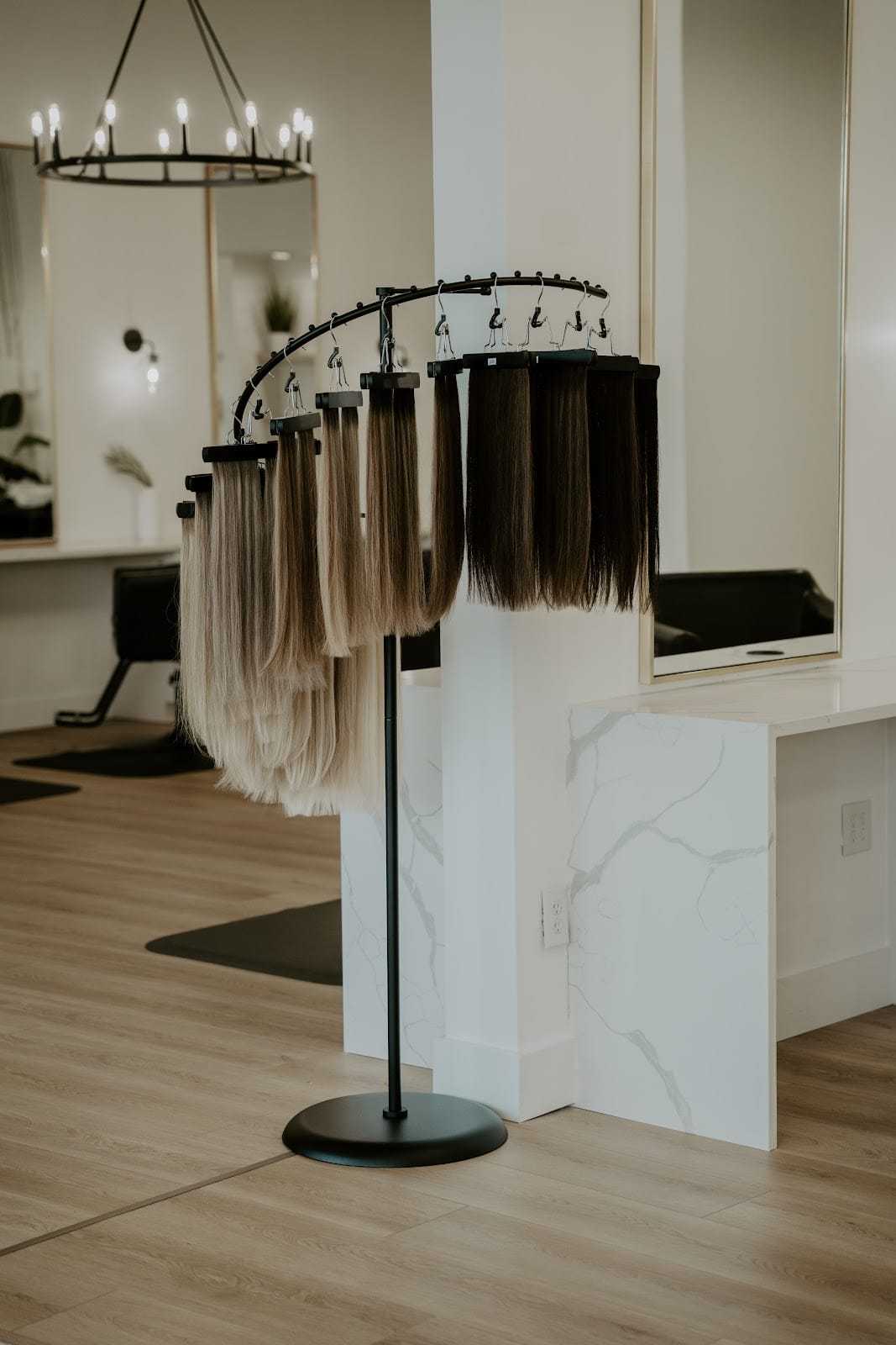 Hair extensions displayed on a stand in a modern salon setting.